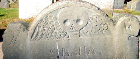 headstone detail from 1683, winged skull, crossbones, hourglass